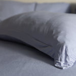 Gray pillow on a bed with a blurred background