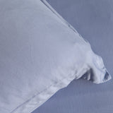Close-up of a light blue pillow on a matching fabric background