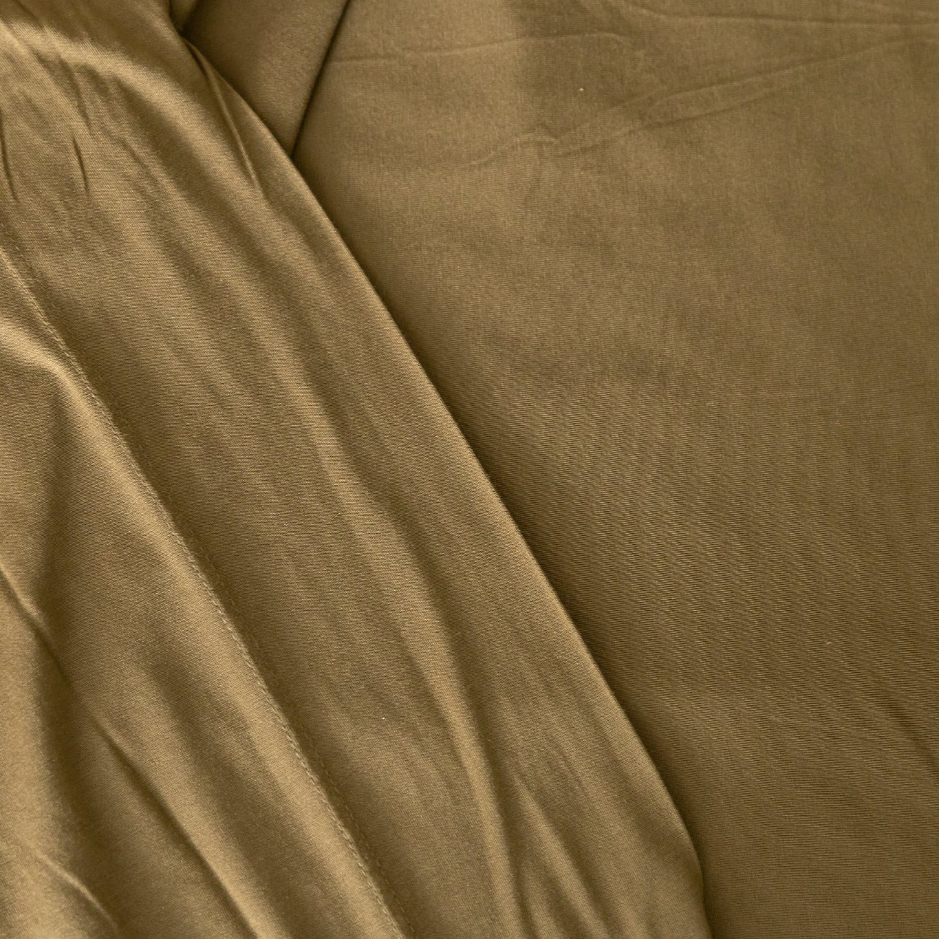 Close-up of forest green jersey knit fabric with visible texture