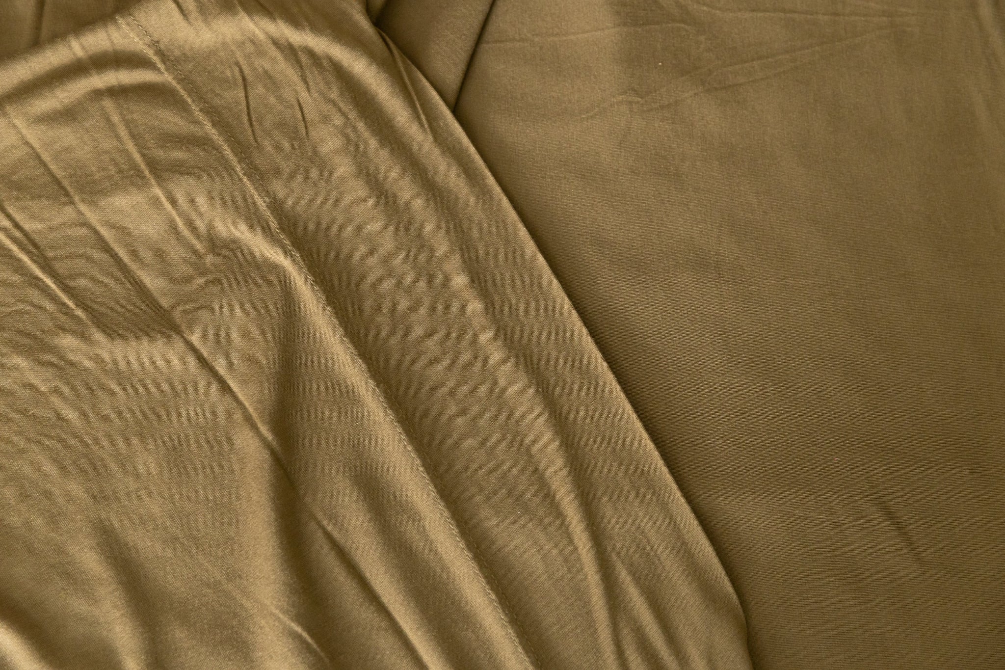 Close-up of forest green jersey knit fabric with visible texture