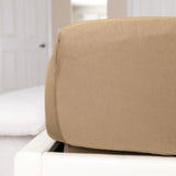 Brown fitted sheet on a white bed in a bedroom setting