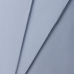 Close-up of a jersey knit textured blue fabric with a subtle pattern