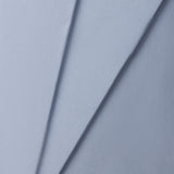 Close-up of a jersey knit textured blue fabric with a subtle pattern