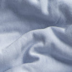 Close-up of jersey knit textured blue fabric with folds