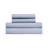 Set of light blue bed sheets stacked on a white background