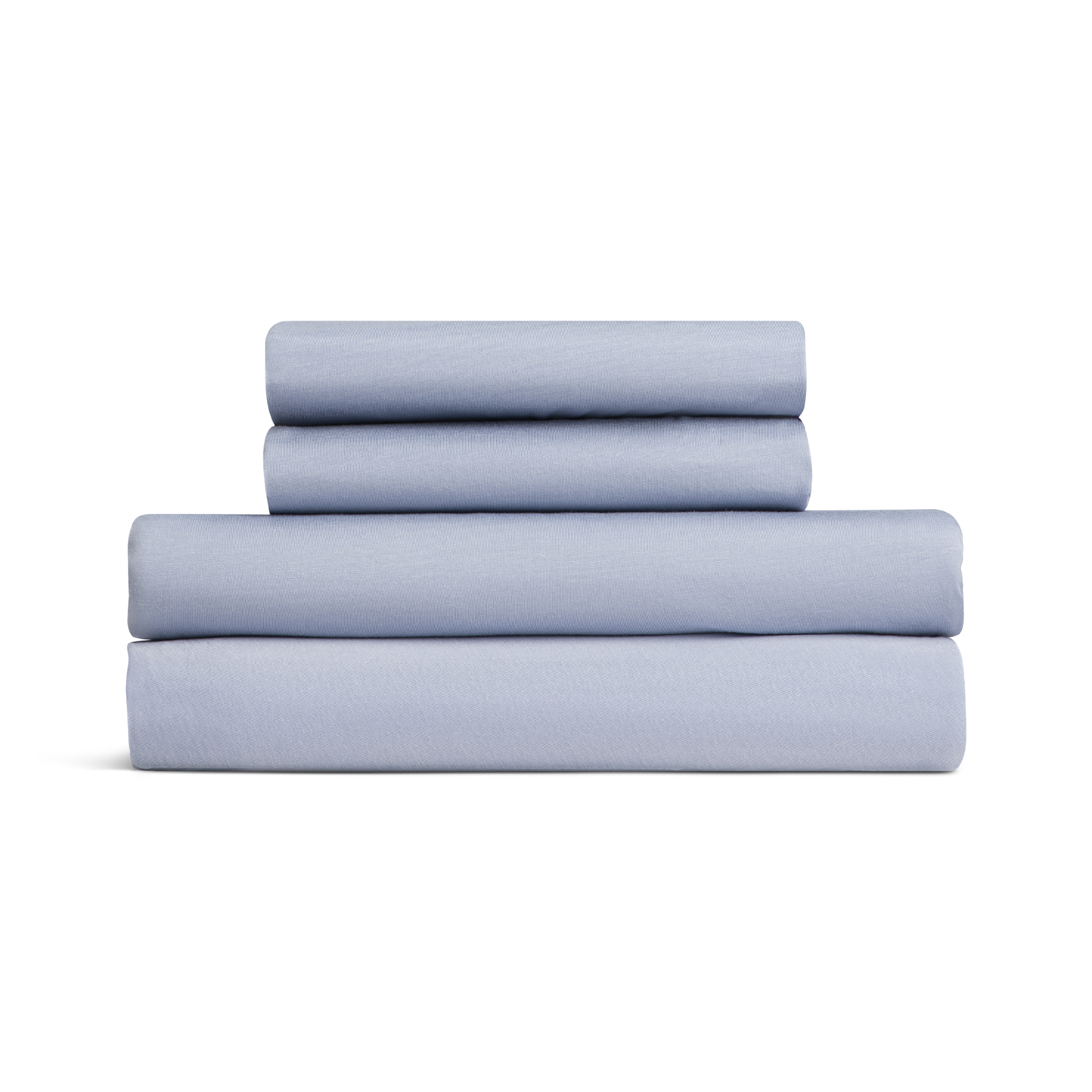 Set of light blue bed sheets stacked on a white background