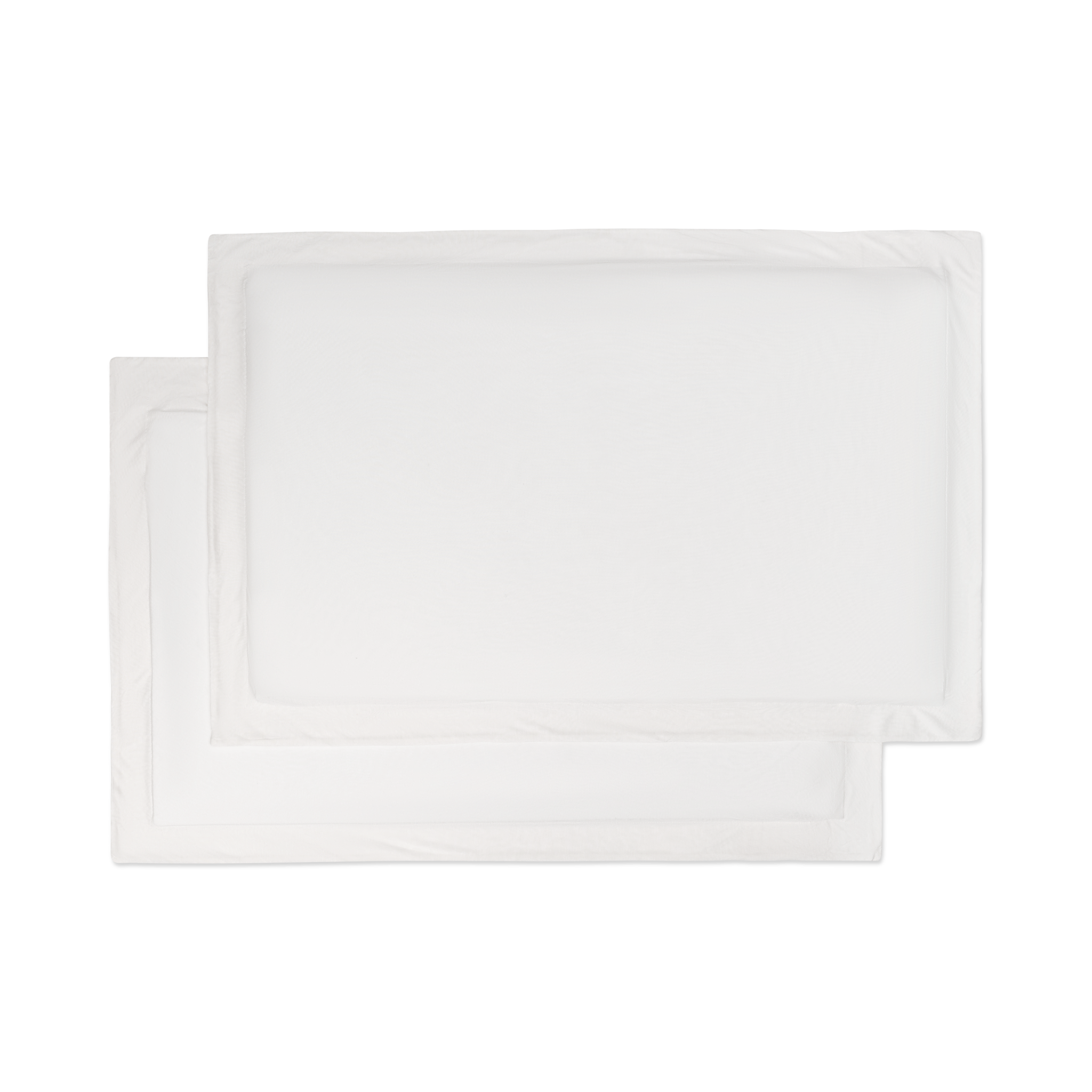 A set of flat lay white jersey knit sham pillowcases.