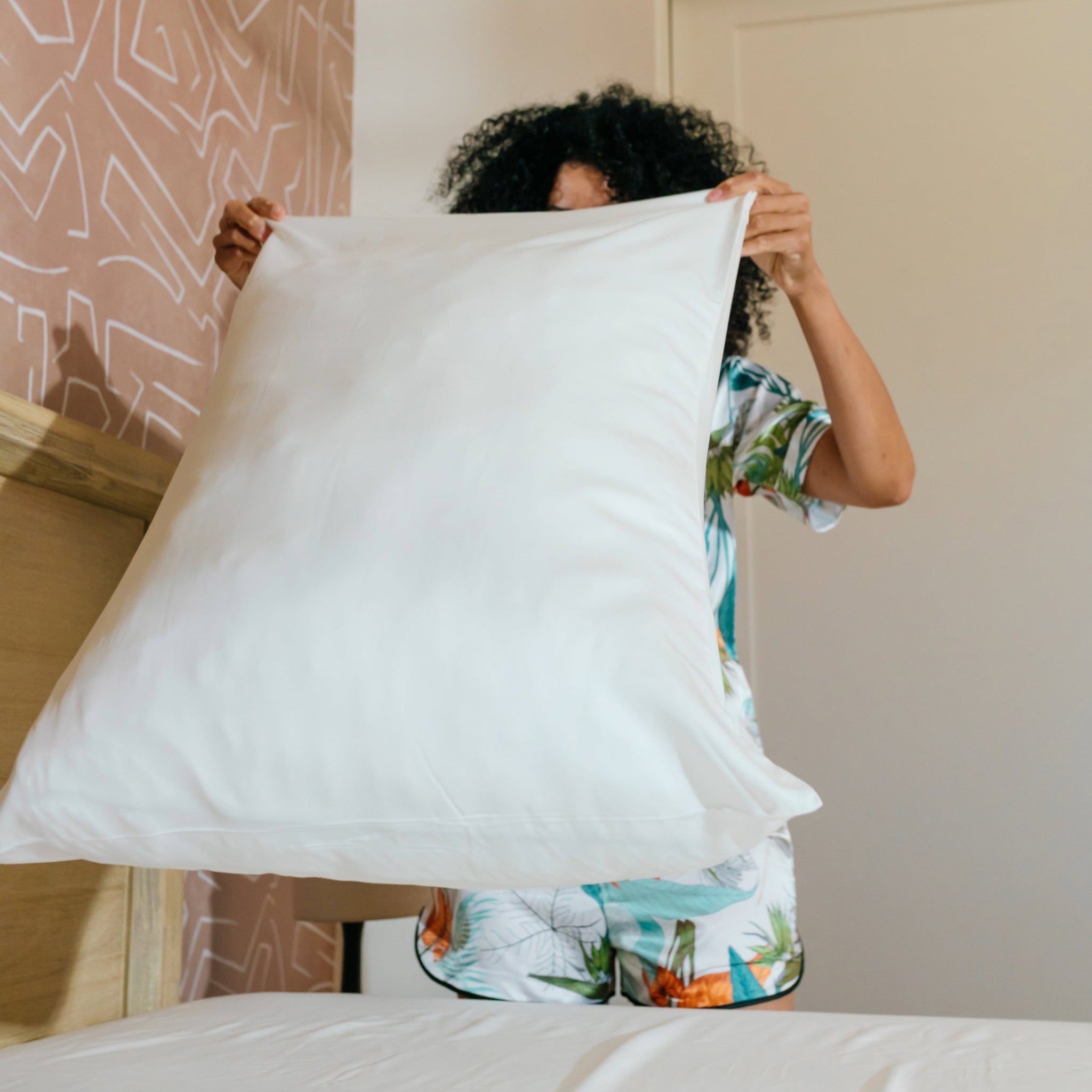 woman tossing pillow