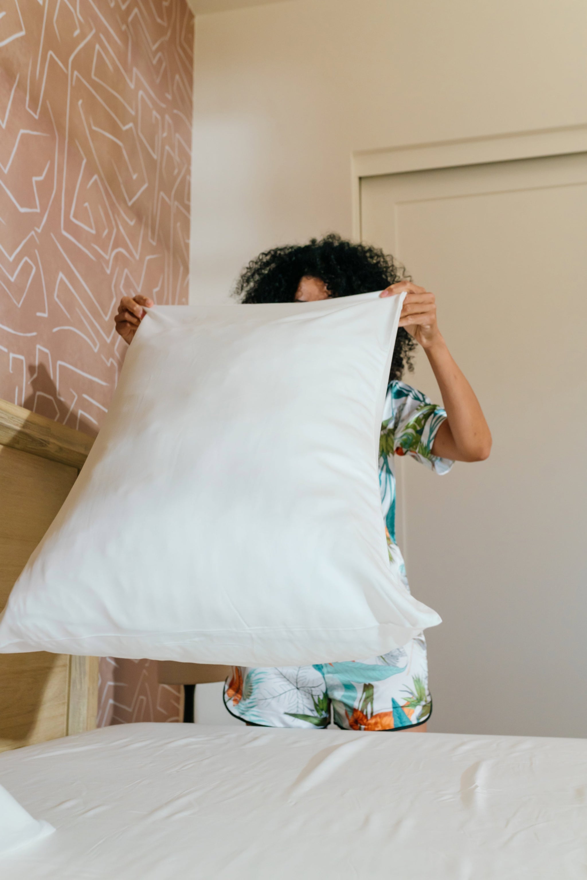 woman tossing pillow